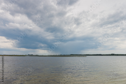 Lake in windy and cloudy weather.  © Roman