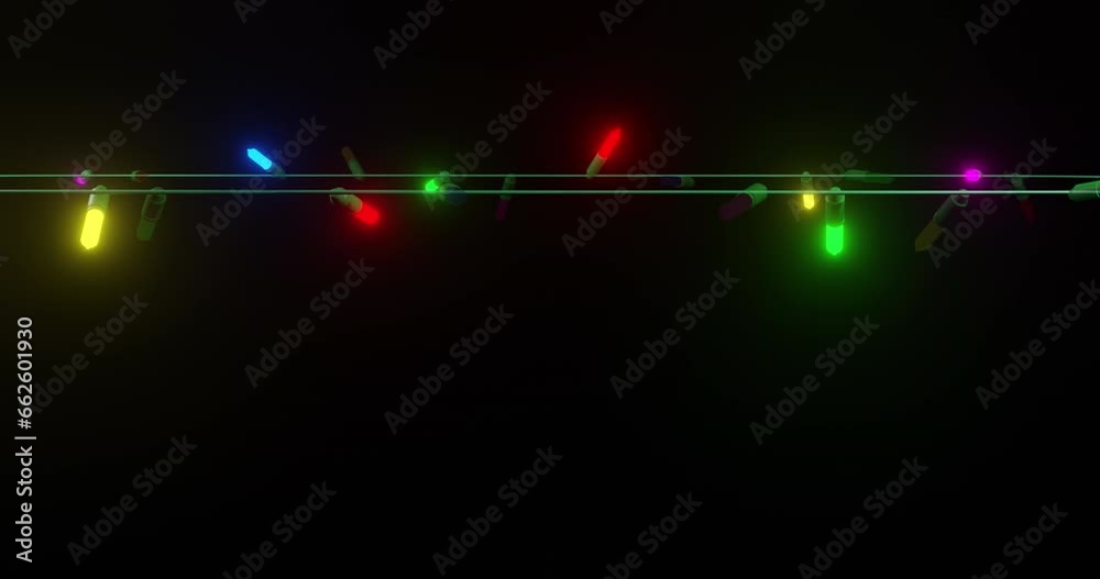 Strand of coloured christmas string lights flashing on black background, copy space
