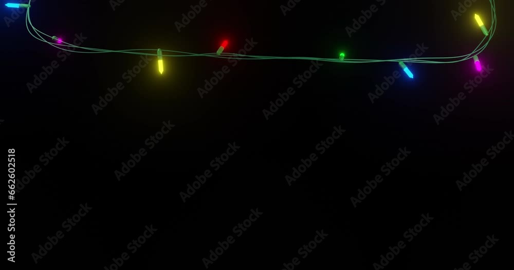 Strand of coloured christmas string lights flashing on black background, copy space