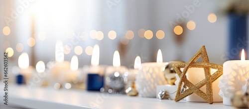Closeup of lovely Hanukkah table decor in living room With copyspace for text photo