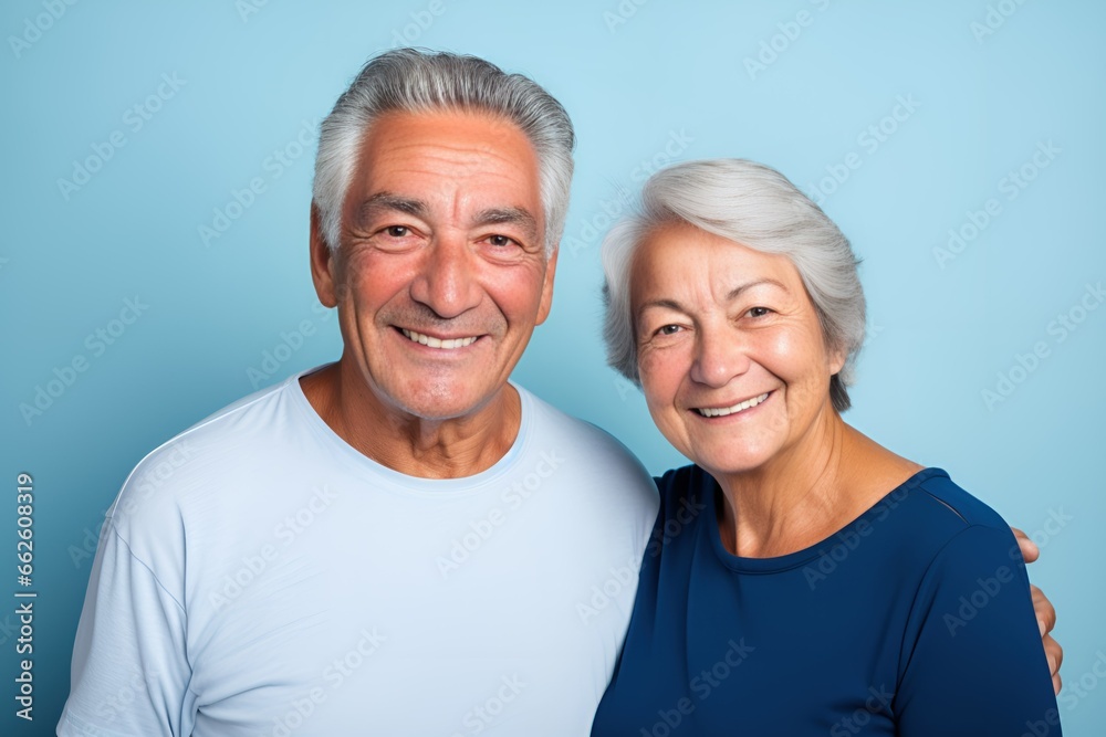 Portrait of a Fictional Lovely Senior Couple wearing plain blank t-shirt on a colored background. Generative AI Illustration. Portrait of a Fictional Lovely Senior Couple wearing plain blank t-shirt on a colored background. Generative AI Illustration.