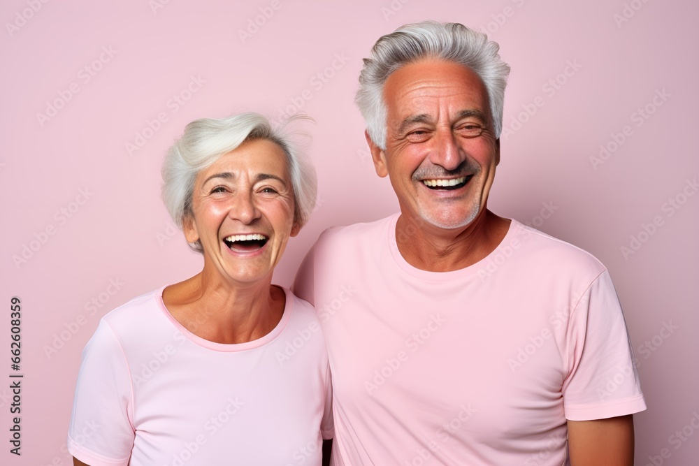 Portrait of a Fictional Lovely Senior Couple wearing plain blank t-shirt on a colored background. Generative AI Illustration. Portrait of a Fictional Lovely Senior Couple wearing plain blank t-shirt on a colored background. Generative AI Illustration.