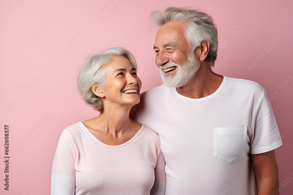 Portrait of a Fictional Lovely Senior Couple wearing plain blank t-shirt on a colored background. Generative AI Illustration. Portrait of a Fictional Lovely Senior Couple wearing plain blank t-shirt on a colored background. Generative AI Illustration.