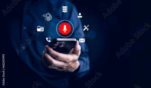 Businessman using smartphone touch microphone button on virtual screen. Blog blog speak talk advertising presentation,Voice recognition, speech detection and deep learning application,Voice Assistance