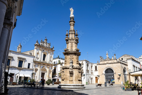 NARDO', ITALY, JULY 17, 2022 - View of the church of Saint Tryphon (San Trifone) and the Spire of the Immaculate  in the center town of Nardò, province of Lecce, Puglia, Italy photo