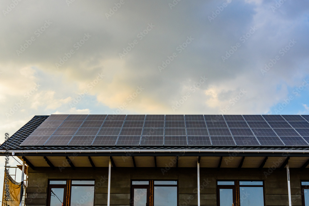Solar panels on roof of residential house. Clean energy. Ecological concept Solar panels on roof of residential house. Clean energy. Ecological concept