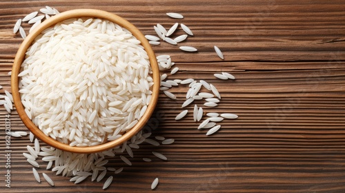 top view of White rice with paddy rice ears on a wood background.
