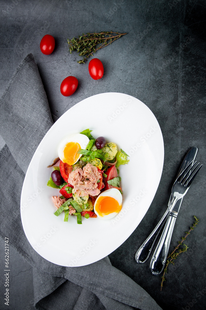salad with soft-boiled egg, tuna, green onions, boiled potatoes, top view salad with soft-boiled egg, tuna, green onions, boiled potatoes, top view