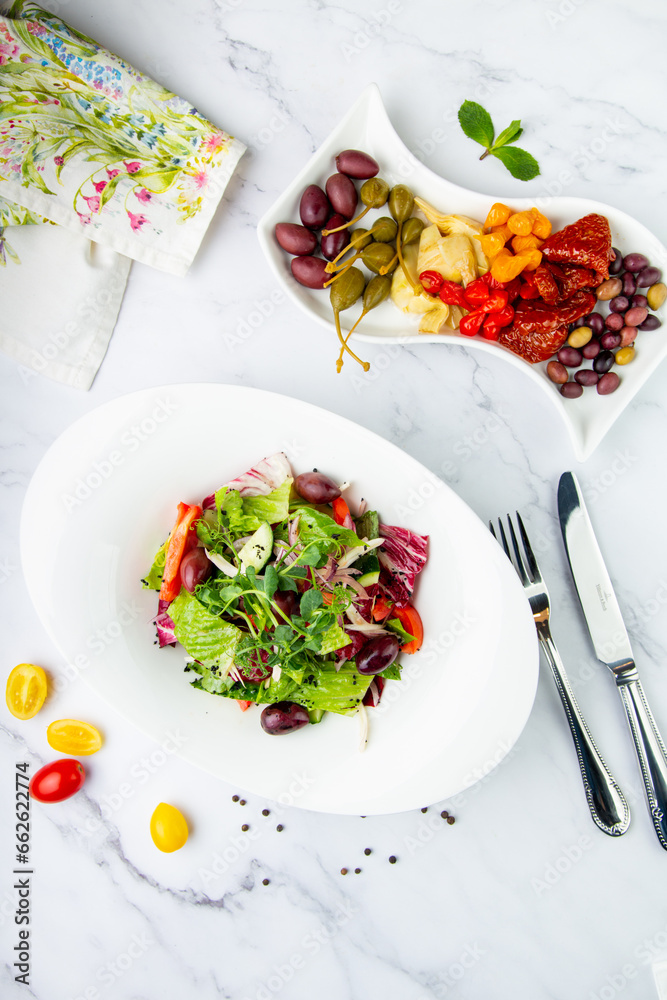 salad of greens, lettuce leaves, cucumbers, pink onions, top view