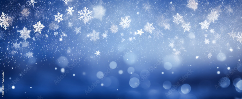 A gentle snowfall, snowflakes appearing as lacy silhouettes, contrasted against a backdrop of inky blue and hazy white bokeh.