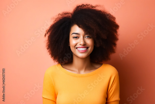 Woman with bright smile and bright yellow sweater.