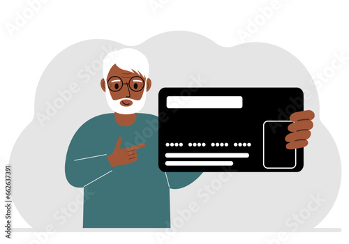 A man holds a large plastic credit card in his hand.