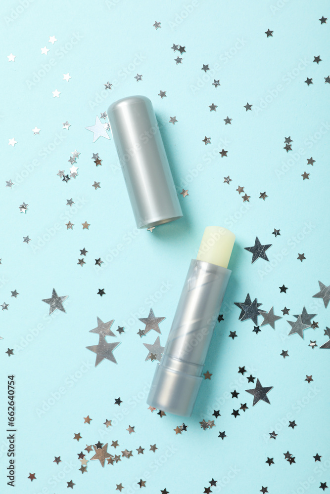 Lip balm on blue background, top view Lip balm on blue background, top view