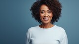 Middle aged african american woman against a blue background isolated happy, smiling and cheerful