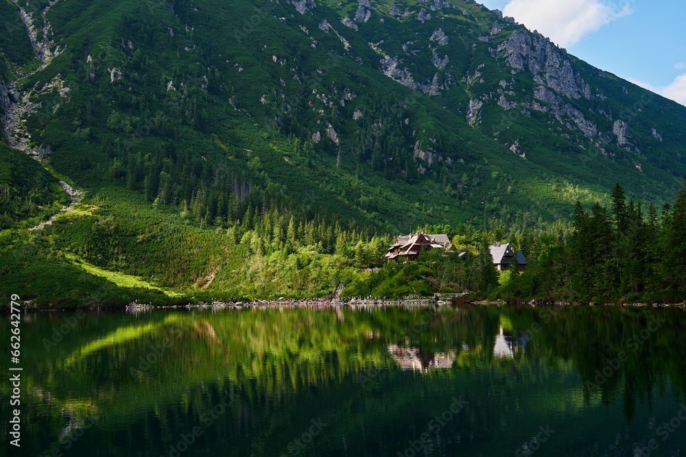 View on cabin in mountains with green forest. House for tourists in Tatra National Park near Morskie Oko or Eye Sea lake. Touristic place in Poland