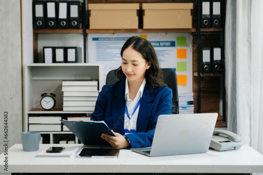 Portrait of female office businesswoman startup daydreaming about her work, startup and working with laptop on office desk in office Portrait of female office businesswoman startup daydreaming about her work, startup and working with laptop on office desk in office