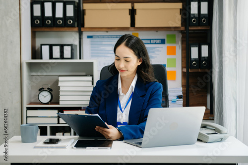 Portrait of female office businesswoman startup daydreaming about her work, startup and working with laptop on office desk in office