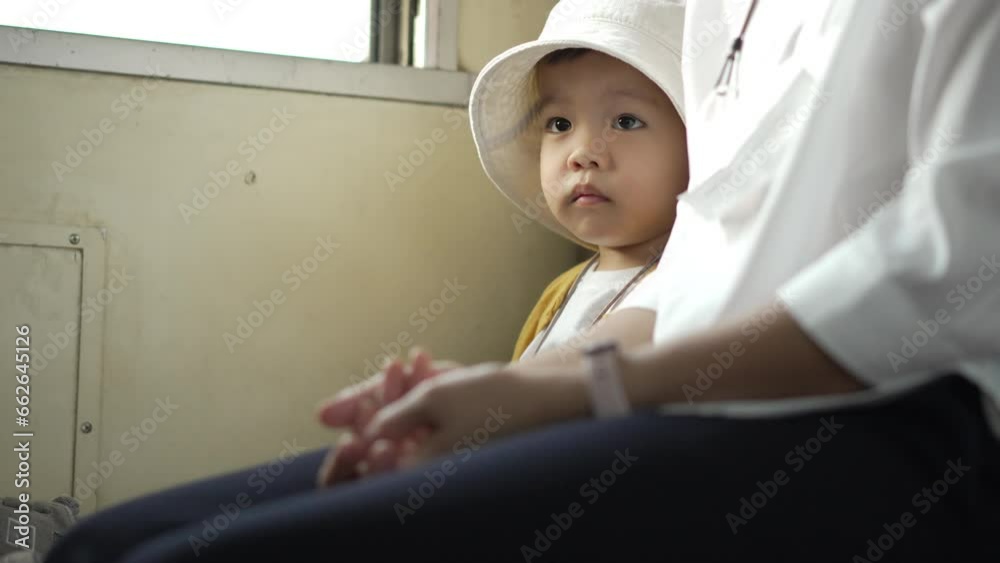 Asian mother and little child boy traveling by train on holiday together Asian mother and little child boy traveling by train on holiday together