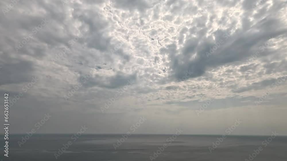 Timelapse fluffy Cumulus clouds moving in bright sunset sky over calm sea. Abstract aerial nature summer ocean sunset, sea and sky view. Vacation, travel, holiday concept. Weather and Climate Change Timelapse fluffy Cumulus clouds moving in bright sunset sky over calm sea. Abstract aerial nature summer ocean sunset, sea and sky view. Vacation, travel, holiday concept. Weather and Climate Change