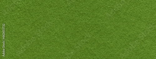Texture of dark green and olive colors paper background, macro. Structure of dense lime craft cardboard.