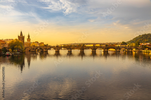 Autumn views from Prague. Picturesque autumn Prague in the morning sun. The Vltava River with the Charles Bridge, the waterfront and houses of Mala Strana and the dominant Prague Castle. Czechia © Pavel Rezac