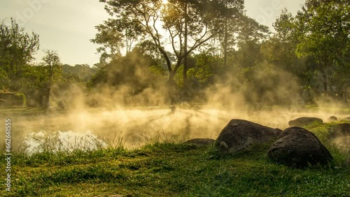 Fog and smoke float above the water surface. Pan right shot. Hot spring at Chae Son National Park, Lampang Province, Thailand