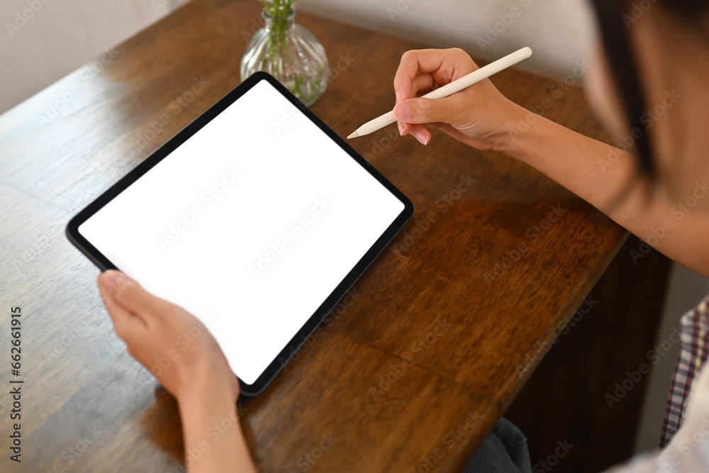 Cropped shot of woman using stylus pen wiring on digital tablet. People, technology and lifestyle