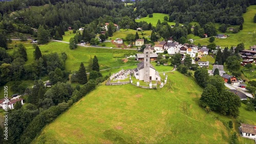 Beautiful medieval Swiss stone church in a peaceful alpine village surrounded by green landscape featuring Chiesa Di San Giorgio in Prato Leventina in Ticino in Switzerland 
 photo