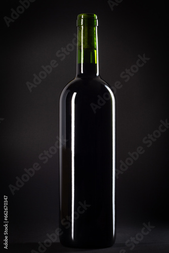 Bottle of red wine on a black background, studio shot.