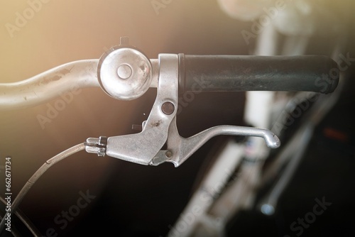 Close up of bicycle handlebar with blur background, vintage tone. photo