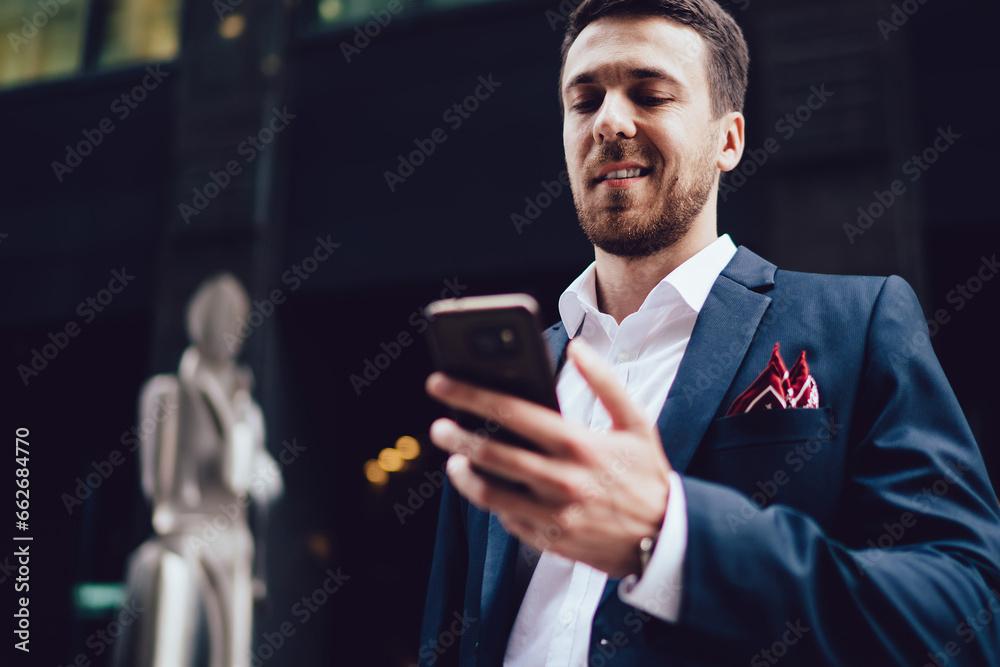 Fototapeta premium Successful businessman using smartphone in city
