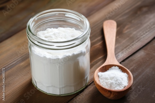 collagen powder in a glass jar on a wood table