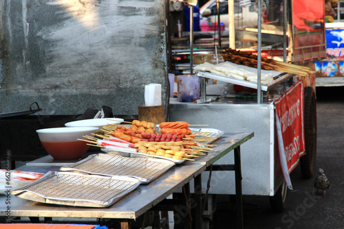 In the market, there are ready-to-sell trays of sausage-filled meatballs.