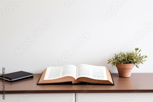 an opened scripture on a minimalist desk setup photo