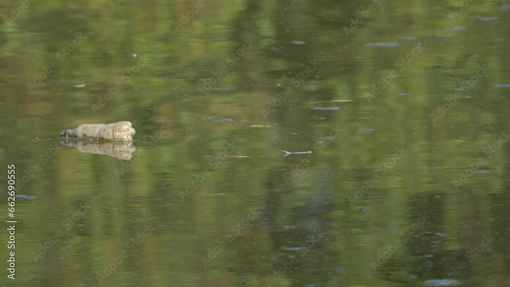 Garbage and plastic waste float on water - (4K) Garbage and plastic waste float on water - (4K)