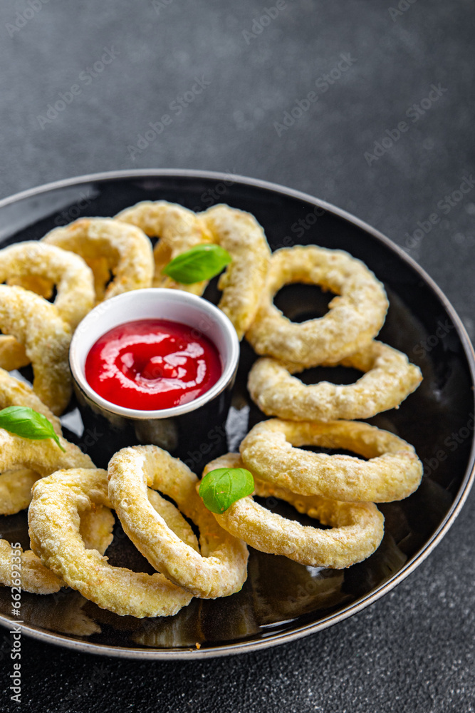 onion rings in batter deep fryer tomato sauce fast food delicious eating cooking appetizer meal food snack on the table copy space onion rings in batter deep fryer tomato sauce fast food delicious eating cooking appetizer meal food snack on the table copy space