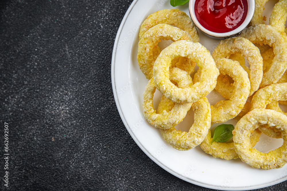 onion rings in batter deep fryer tomato sauce fast food delicious eating cooking appetizer meal food snack on the table copy space