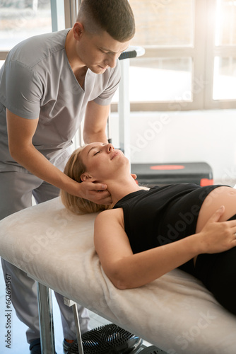 Massage therapist conducts a manual therapy session for pregnant client