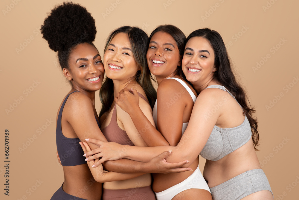 Fototapeta premium Multiracial women, naturally beautiful, pose together over beige background