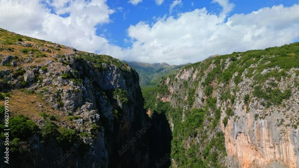 Aerial drone backward moving shot of canyon along Gjipe Beach in Albania on a sunny day. Aerial drone backward moving shot of canyon along Gjipe Beach in Albania on a sunny day.