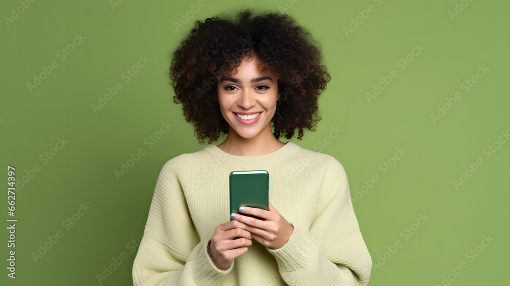 african descendant woman checking her smartphone on green background, copy space african descendant woman checking her smartphone on green background, copy space