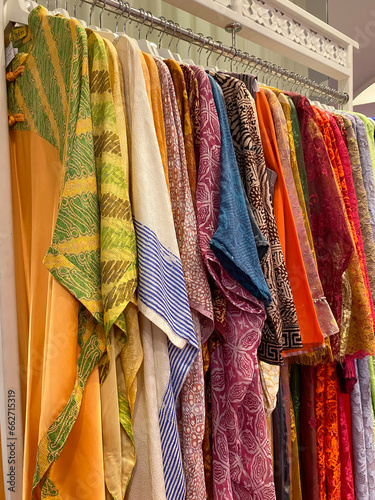 Colourful batik cloth hanging neatly on the display of a boutique