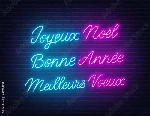 Joyeux Noel  Bonne Annee and Meilleurs Voeux neon lettering on brick wall background. Merry Christmas, Happy New Year and Best wishes greetings  greetings in French