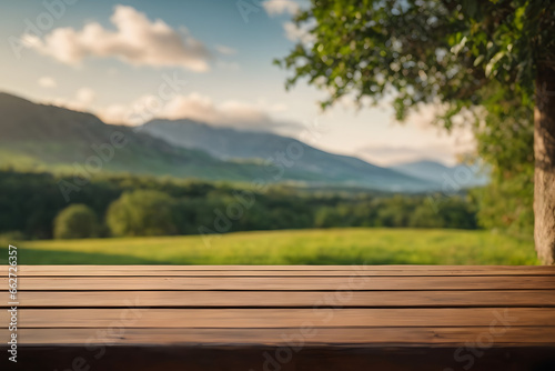 Empty wooden table in the field with nature hills background, Mock up template, display of product. © Almultazam