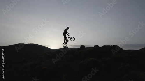 Drone Footage of Trial Biking on Rocky Terrain at Sunset 2 photo