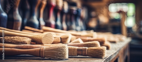 Close up view of artisan made wooden tools including shoe brushes and mashers at a woodworker s shop with a shallow depth of field With copyspace for text photo