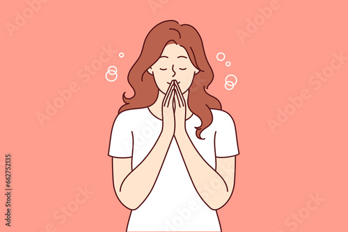 Praying woman performs meditation or religious ritual to purify thoughts and get rid of bad emotions. Casual girl stands with eyes closed and does meditation to achieve balance between body and soul