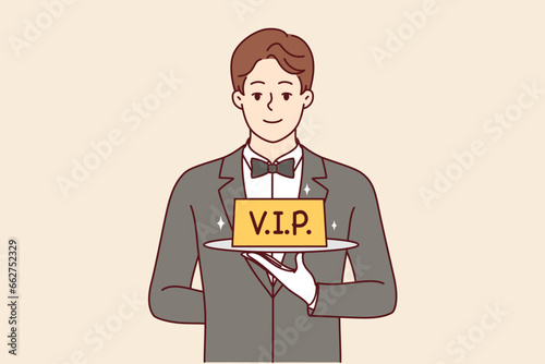 Man restaurant waiter holds vip sign on tray, offering to book table with personalized service. Guy in suit and white gloves works as professional waiter in catering company with vip clients.