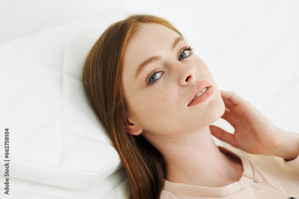 Young woman with clean perfect glow skin in beauty salon. Women Health. Patient waiting diagnosis and medical checkup in hospital. Medicine, healthcare and people concept.