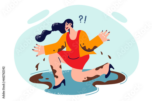 Dirty woman fallen into puddle during rain and unfavorable weather conditions is waiting for help